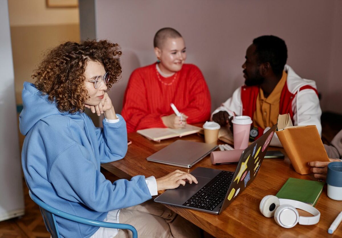 A group of college students studying together at a table.