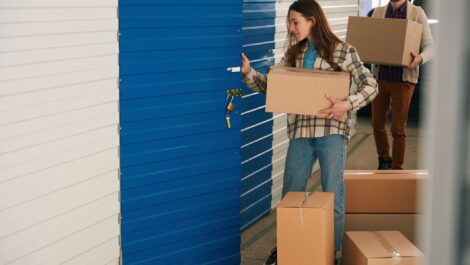 A cozy climate-controlled storage unit with well-organized boxes, furniture, and electronics, shielded from the cold winter outside.